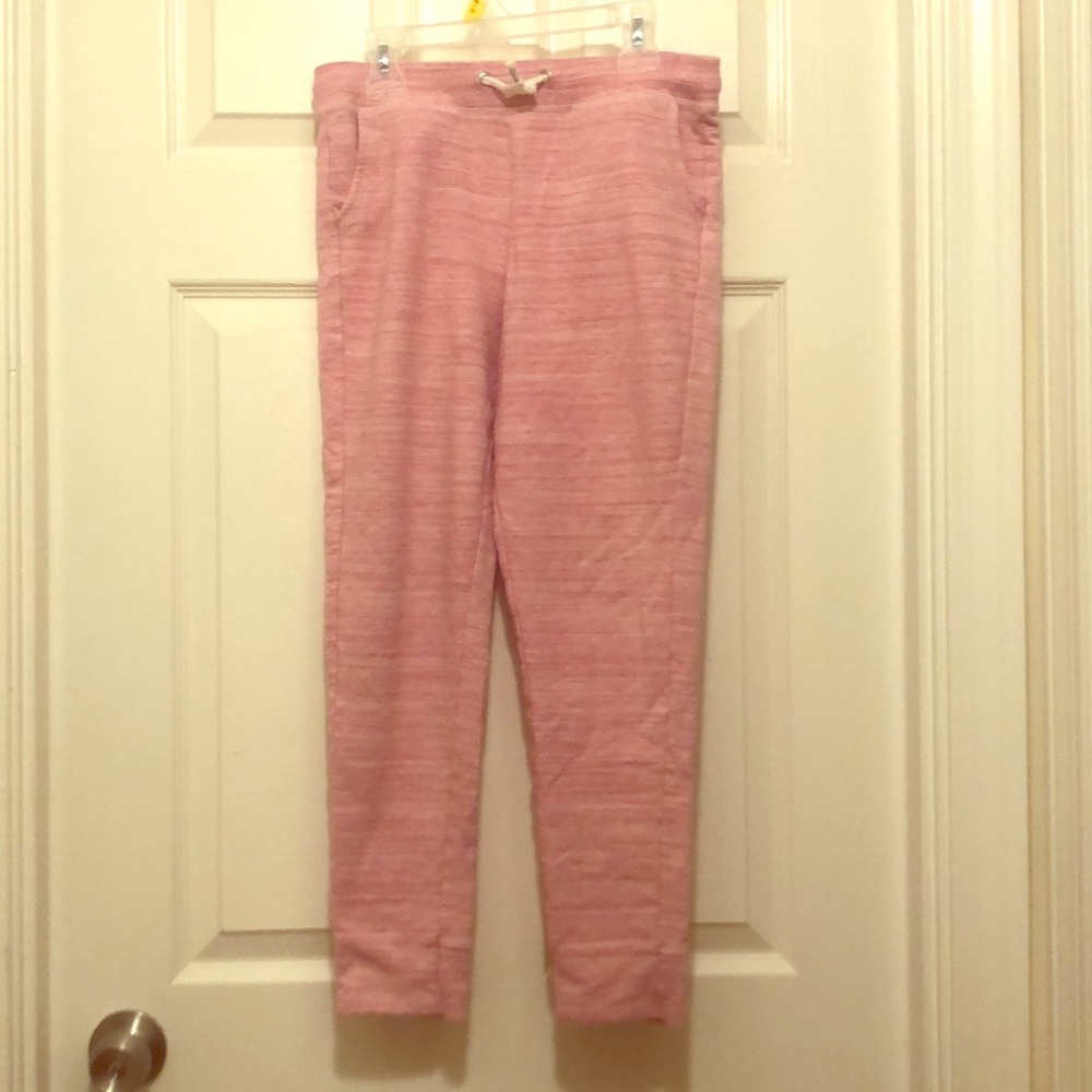 Pink sweatpants with pockets and drawstring.